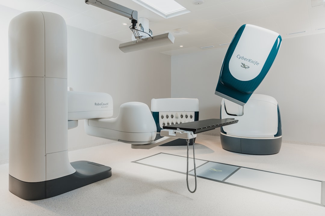 a-room-with-a-chair-and-a-table-with-a-computer-on-it-m38ghirfwfw